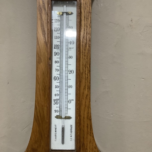 255 - A 20th century oak aneroid banjo barometer, 79cm high