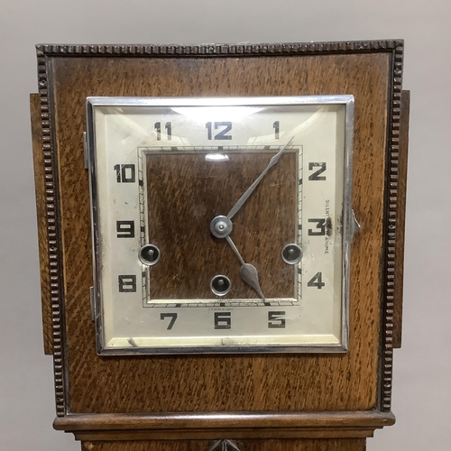 258 - A 1930s oak cased grandmother clock, the square silvered chaptering with black Arabic numerals, eigh... 