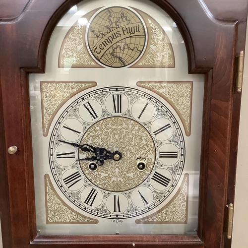 273 - A reproduction longcase clock with arched dial, black Roman numerals, thirty-one day movement, glaze... 