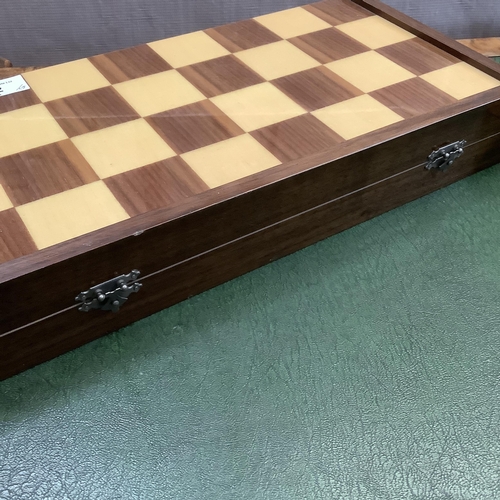 302 - A game box with chequered outer surface, the interior lined in green baize together with a set of ch... 