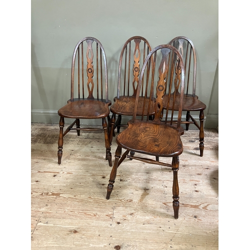 294 - A set of four Glenister elm dining chairs with pierced splat and railed back on turned legs joined b... 