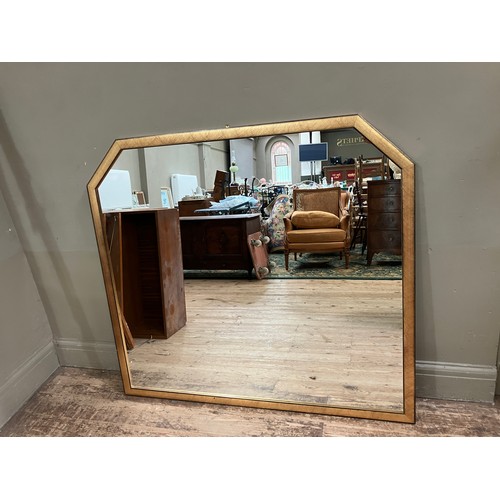 263 - A gilt framed wall mirror with canted corners to the top, 110cm x 120cm