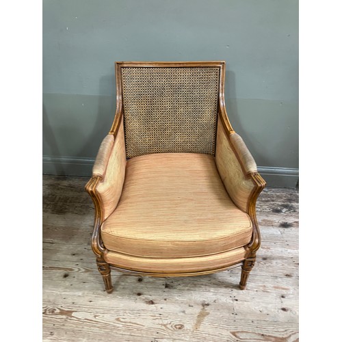 286 - An early 19th century style fruitwood and bergere caned armchair having a square back, upholstered a... 