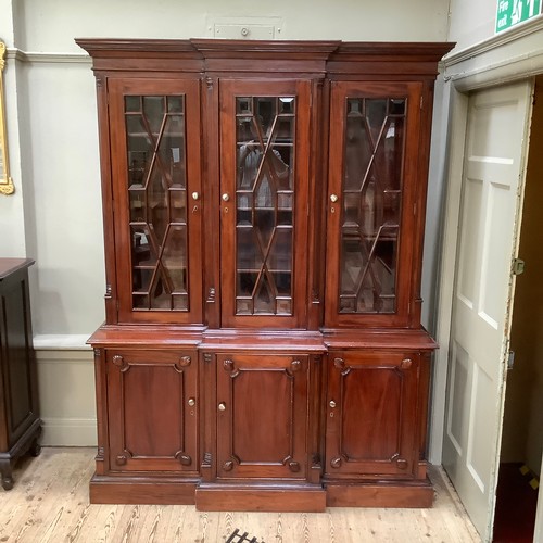 271 - A reproduction 19th century style mahogany breakfront bookcase cupboard having a moulded cornice abo... 