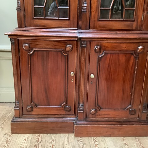 271 - A reproduction 19th century style mahogany breakfront bookcase cupboard having a moulded cornice abo... 