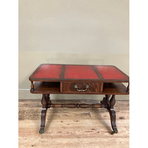 250 - A mahogany and red leather incised coffee table having an under tier with drawer on turned refectory... 