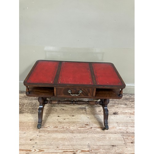 250 - A mahogany and red leather incised coffee table having an under tier with drawer on turned refectory... 