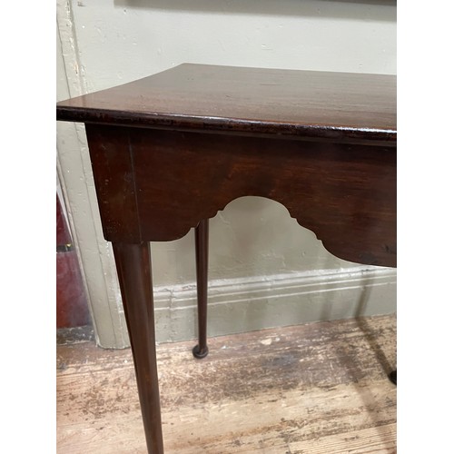 298 - An 18th century and later mahogany table, rectangular, having a deep wavy apron, slender rounded leg... 