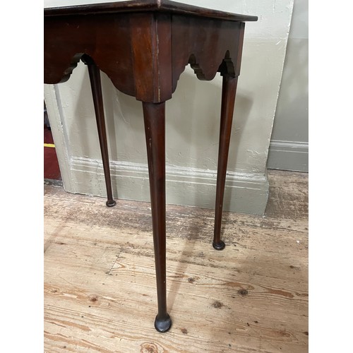 298 - An 18th century and later mahogany table, rectangular, having a deep wavy apron, slender rounded leg... 