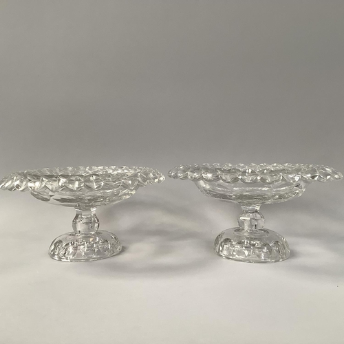 218 - A PAIR OF MID 18TH CENTURY IRISH GLASS PEDESTAL BOWLS, circular with petal edges and disc cut centre... 