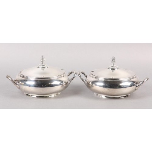 302 - A PAIR OF TUREENS BY ELKINGTON in silver plate each of circular outline with pineapple finials, holl... 