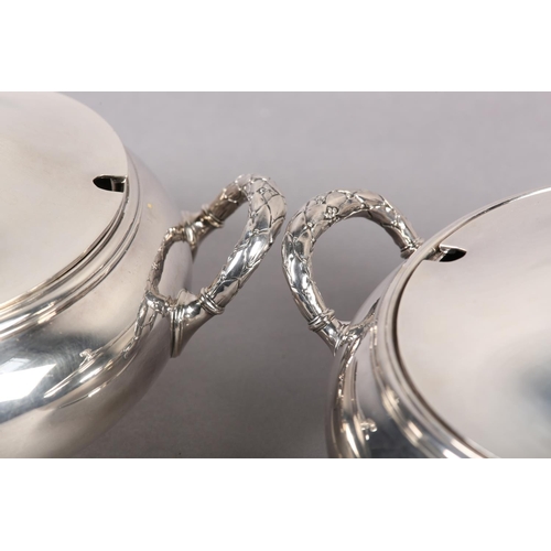 302 - A PAIR OF TUREENS BY ELKINGTON in silver plate each of circular outline with pineapple finials, holl... 