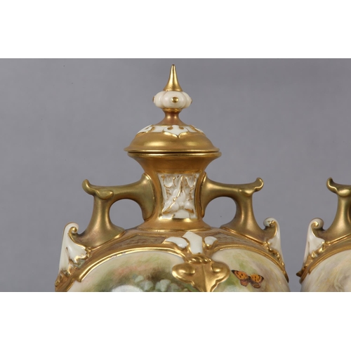 238 - A PAIR OF ROYAL WORCESTER PORCELAIN TWO-HANDLED VASES AND COVERS BY WILLIAM RICKETTS, the ovoid body... 