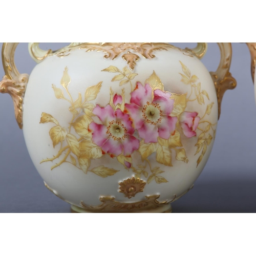 262 - A ROYAL WORCESTER BLUSH IVORY VASE and cover, having twin moulded handles, the ovoid body enamelled ... 