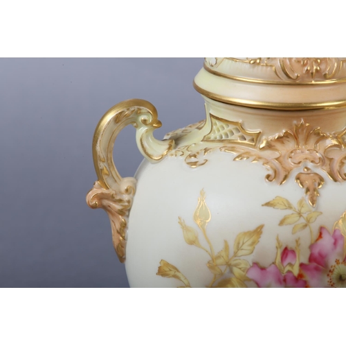 262 - A ROYAL WORCESTER BLUSH IVORY VASE and cover, having twin moulded handles, the ovoid body enamelled ... 