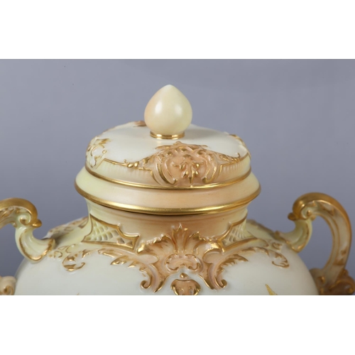 262 - A ROYAL WORCESTER BLUSH IVORY VASE and cover, having twin moulded handles, the ovoid body enamelled ... 