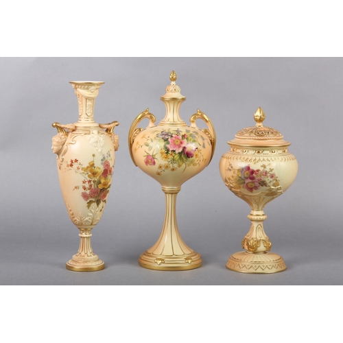 263 - THREE ROYAL WORCESTER BLUSH IVORY VASES one having a pierced cover with finial, the ovoid body ename... 