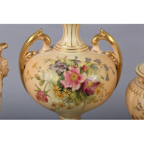 263 - THREE ROYAL WORCESTER BLUSH IVORY VASES one having a pierced cover with finial, the ovoid body ename... 