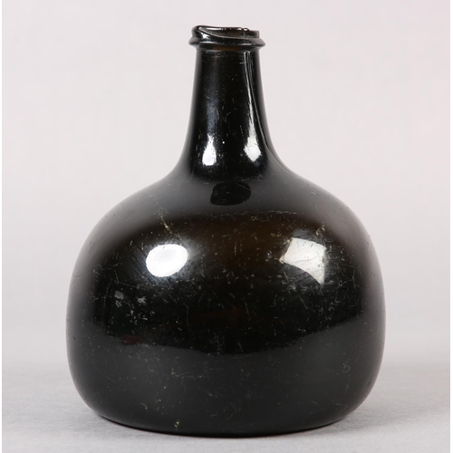 209 - AN EARLY 18TH CENTURY ONION BOTTLE of dark olive-green tint, hand-blown, the rounded body with taper... 