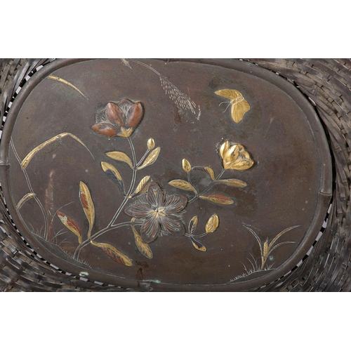 285 - A JAPANESE BRONZE 'BASKET' WALL PLAQUE, the centre panel incised and applied with a spray of blossom... 