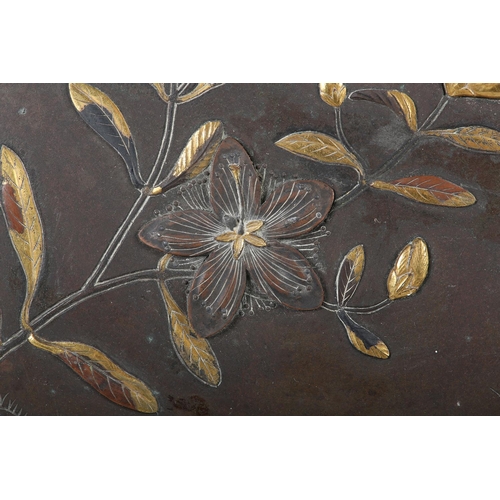 285 - A JAPANESE BRONZE 'BASKET' WALL PLAQUE, the centre panel incised and applied with a spray of blossom... 