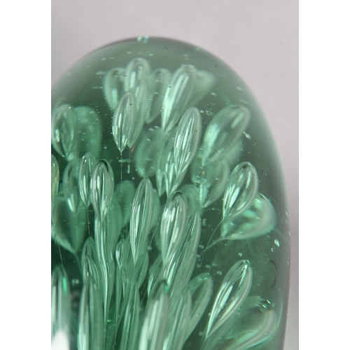 211 - A 19TH CENTURY GREEN GLASS DUMP with bubble inclusions, 17.5cm high