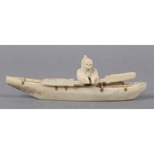 157 - DANNY ETOOANGAT (EDUNGAT) 20/21ST CENTURY, AN INUIT MARINE BONE CARVING OF A KAYAKER, the kayak havi... 