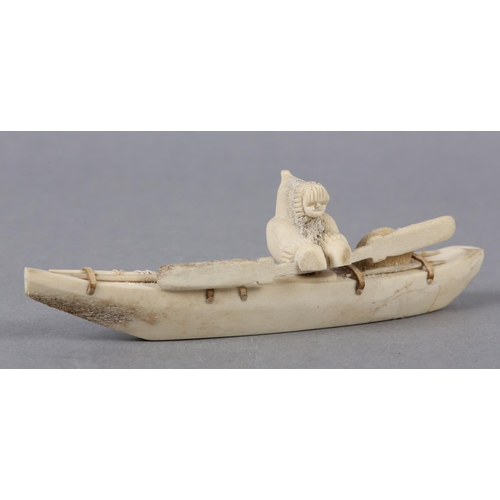 157 - DANNY ETOOANGAT (EDUNGAT) 20/21ST CENTURY, AN INUIT MARINE BONE CARVING OF A KAYAKER, the kayak havi... 