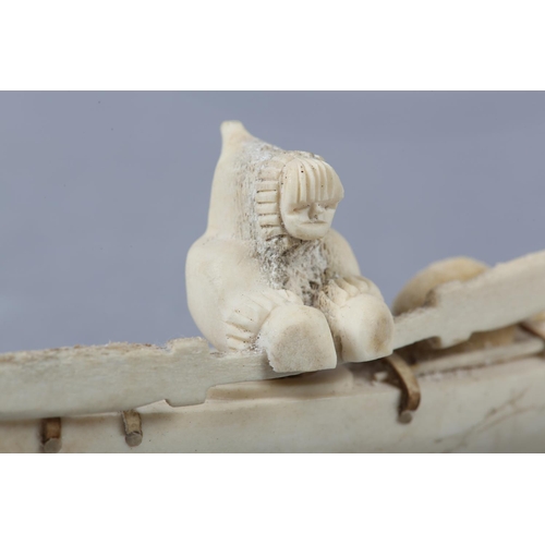 157 - DANNY ETOOANGAT (EDUNGAT) 20/21ST CENTURY, AN INUIT MARINE BONE CARVING OF A KAYAKER, the kayak havi... 