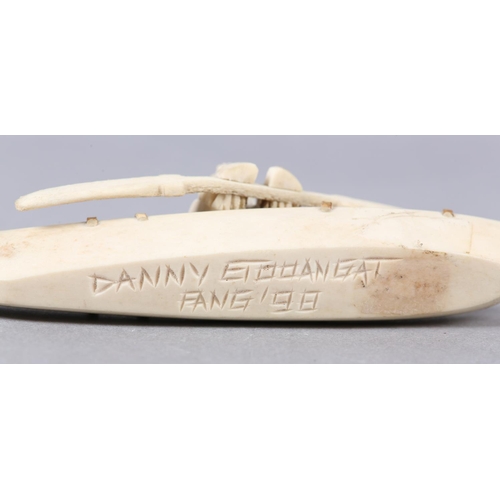 157 - DANNY ETOOANGAT (EDUNGAT) 20/21ST CENTURY, AN INUIT MARINE BONE CARVING OF A KAYAKER, the kayak havi... 