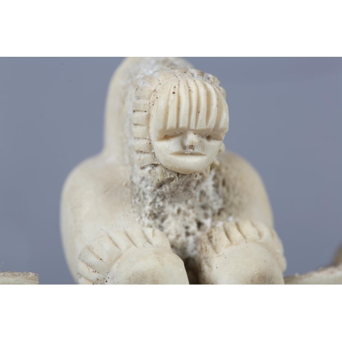 157 - DANNY ETOOANGAT (EDUNGAT) 20/21ST CENTURY, AN INUIT MARINE BONE CARVING OF A KAYAKER, the kayak havi... 