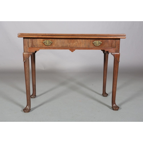 478 - A GEORGE III MAHOGANY TEA TABLE having a rectangular fold over top above a drawer to the apron, late... 