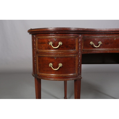 479 - A MAHOGANY KIDNEY SHAPE DESK circa 1920s, having a pierced brass gallery and leather incised writing... 