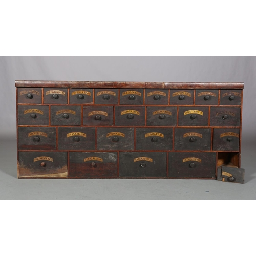 492 - A 19TH CENTURY BANK OF APOTHECARY'S DRAWERS, pine, with ebonised and labelled drawer fronts, of four... 