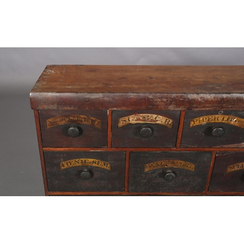 492 - A 19TH CENTURY BANK OF APOTHECARY'S DRAWERS, pine, with ebonised and labelled drawer fronts, of four... 