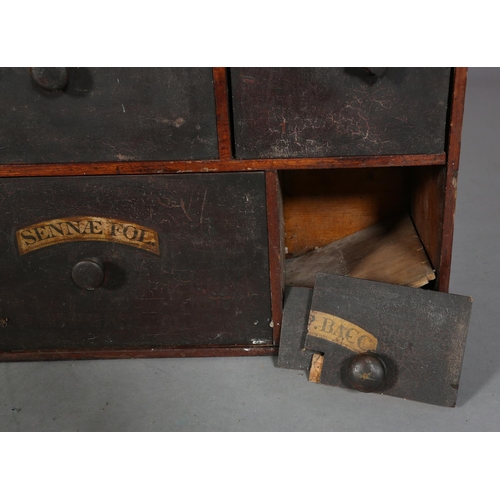 492 - A 19TH CENTURY BANK OF APOTHECARY'S DRAWERS, pine, with ebonised and labelled drawer fronts, of four... 