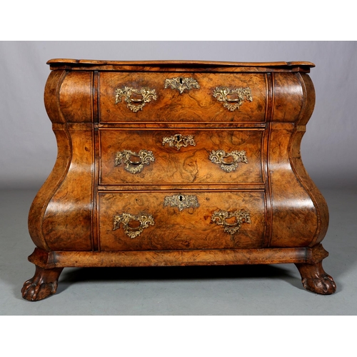 467 - A 18TH CENTURY DUTCH FIGURED WALNUT BOMBE COMMODE, the quarter veneered top of serpentine outline, a... 