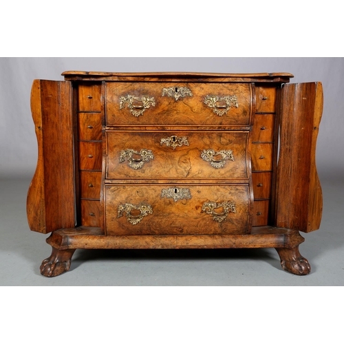 467 - A 18TH CENTURY DUTCH FIGURED WALNUT BOMBE COMMODE, the quarter veneered top of serpentine outline, a... 