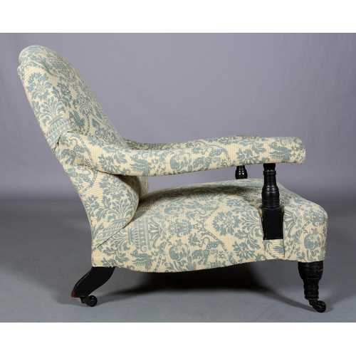 470 - A 19TH CENTURY ARMCHAIR IN THE STYLE OF HOWARD & SONS, the rounded back, arms and low seat upholster... 