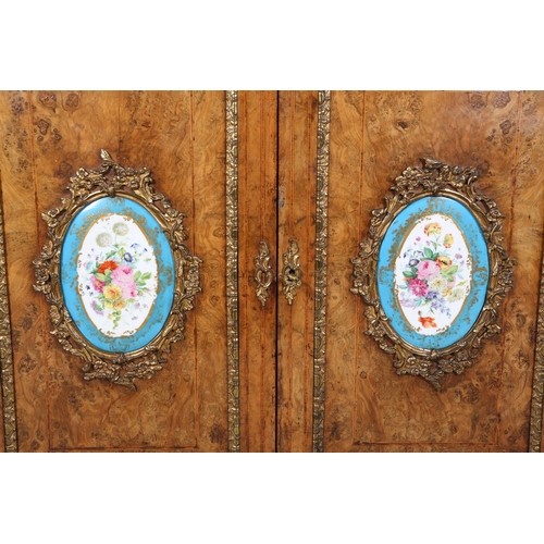 472 - A VICTORIAN FIGURED WALNUT CREDENZA OR SIDE CABINET with gilt metal mounts and floral painted porcel... 