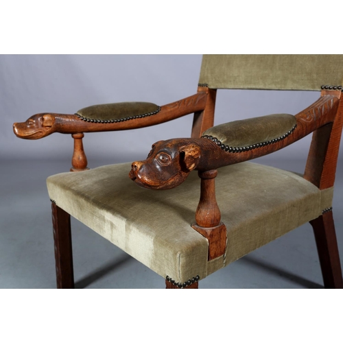 488 - A LATE 19TH CENTURY OAK OPEN ARMCHAIR having an upholstered panel back, arm pads and seat, the arms ... 