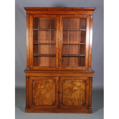 471 - AN EARLY 19TH CENTURY MAHOGANY BOOKCASE-CUPBOARD having a moulded cornice above two glazed tracery d... 