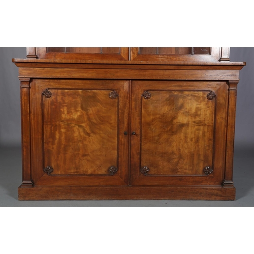 471 - AN EARLY 19TH CENTURY MAHOGANY BOOKCASE-CUPBOARD having a moulded cornice above two glazed tracery d... 