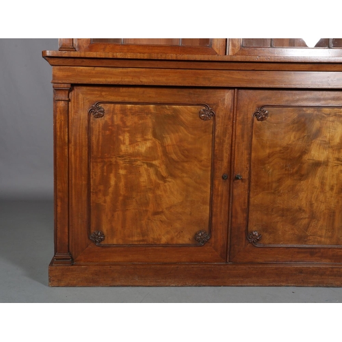 471 - AN EARLY 19TH CENTURY MAHOGANY BOOKCASE-CUPBOARD having a moulded cornice above two glazed tracery d... 