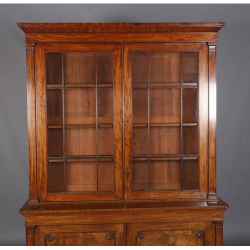 471 - AN EARLY 19TH CENTURY MAHOGANY BOOKCASE-CUPBOARD having a moulded cornice above two glazed tracery d... 