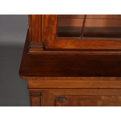 471 - AN EARLY 19TH CENTURY MAHOGANY BOOKCASE-CUPBOARD having a moulded cornice above two glazed tracery d... 