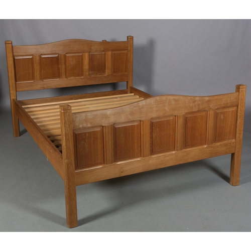 466 - COLIN ALMACK 'BEAVERMAN', an oak bedstead, having a five indented panel head and footboard of arched... 