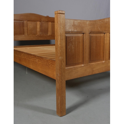 466 - COLIN ALMACK 'BEAVERMAN', an oak bedstead, having a five indented panel head and footboard of arched... 