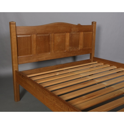 466 - COLIN ALMACK 'BEAVERMAN', an oak bedstead, having a five indented panel head and footboard of arched... 