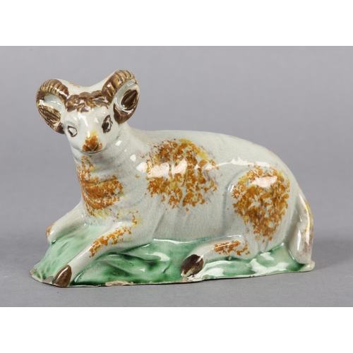 278 - AN 18TH CENTURY PRATTWARE FIGURE OF A RAM, the pearlware body sponged in ochre, manganese brown and ... 